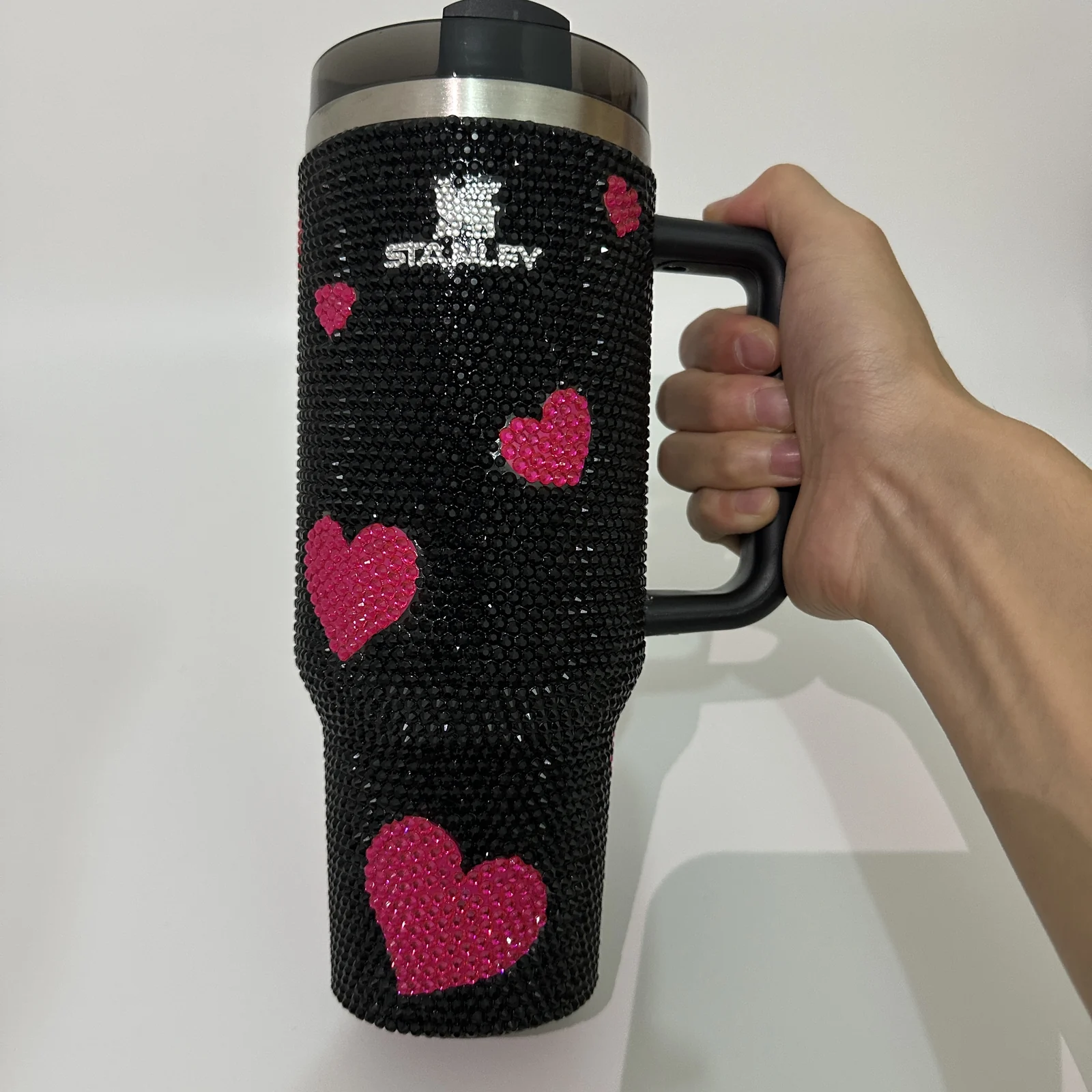 Black rhinestone tumbler with pink heart decoration and handle
