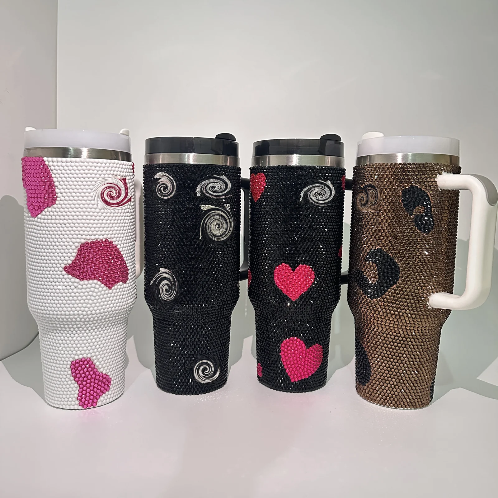 Black and pink heart rhinestone tumbler shown with related drinkware designs