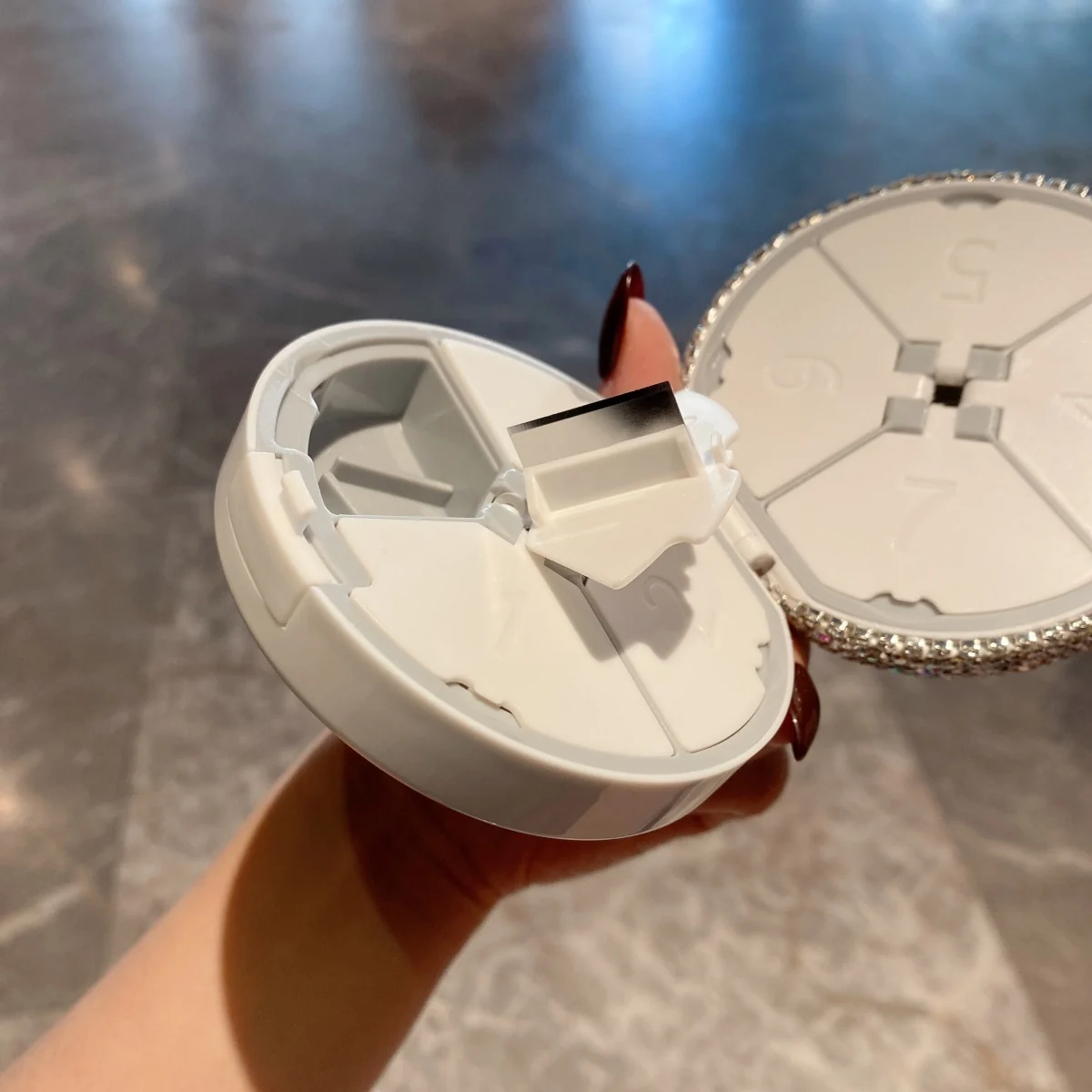 Opened crystal seven-day pill organizer showing inner compartments