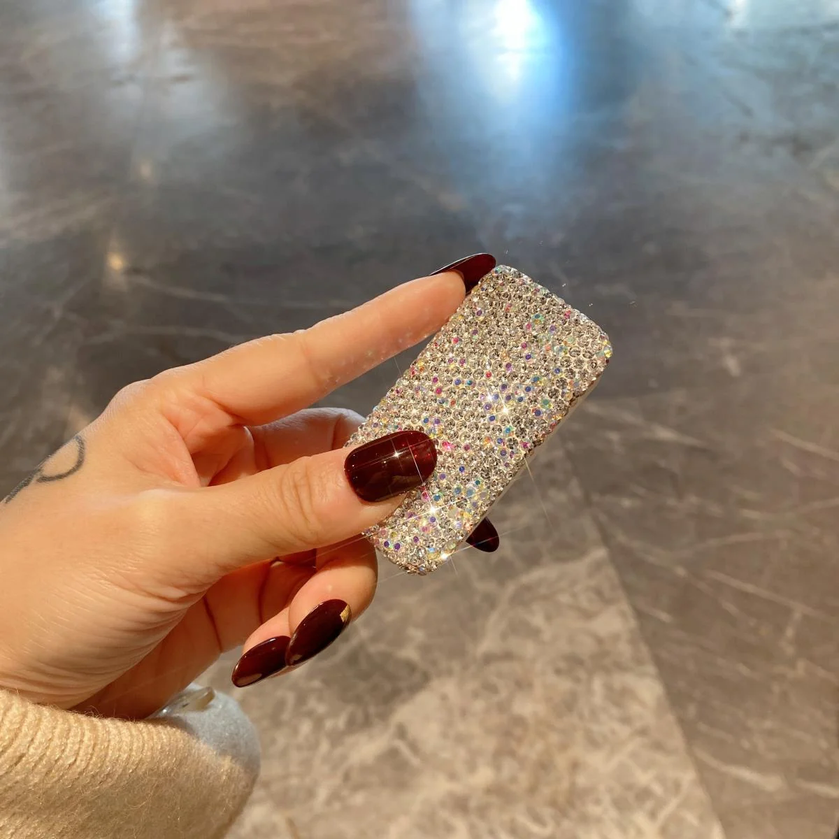 Closed three-compartment rhinestone pill box in hand